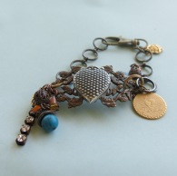 8 inch multip metal and vintage items for a funky hippy & bohemian bracelet. Handmade by me!